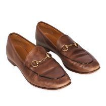 GUCCI BROWN HORSE BIT LOAFERS Condition grade C-. Size 37. Brown toned leather loafers with alm...