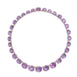 AN AMETHYST RIVIERE NECKLACE in 9ct yellow gold, set with a row of graduating oval cut amethysts,...