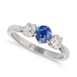 A SAPPHIRE AND DIAMOND THREE STONE RING in platinum, set with a cushion cut sapphire between two ...