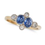 A SAPPHIRE AND DIAMOND DRESS RING in 18ct yellow gold and platinum, set with two oval cut sapphir...