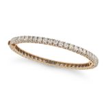A DIAMOND BANGLE in yellow gold, the hinged bangle set all around with a row of round brilliant c...