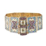 AN ENAMEL AND RUBY BOOK BRACELET in 14ct yellow gold, the book opening up to reveal enamelled pan...