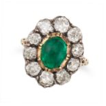 AN ANTIQUE EMERALD AND DIAMOND CLUSTER RING in yellow gold and silver, set with a cabochon emeral...