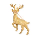 TIFFANY & CO., A VINTAGE RUBY STAG BROOCH in 18ct yellow gold, designed as a textured stag, the e...