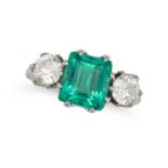 A FINE COLOMBIAN EMERALD AND DIAMOND THREE STONE RING in platinum, set with an octagonal step cut...