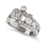 A DIAMOND DRESS RING in platinum, the open band in geometric design, set with a fancy cut and bag...