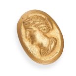 A GOLD CAMEO RING in high carat yellow gold, the oval face with the profile of a classical woman ...