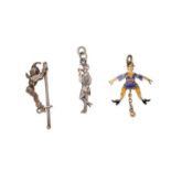 A GROUP OF JESTER CHARM / PENDANTS each designed as a jester, one decorated with purple and yello...