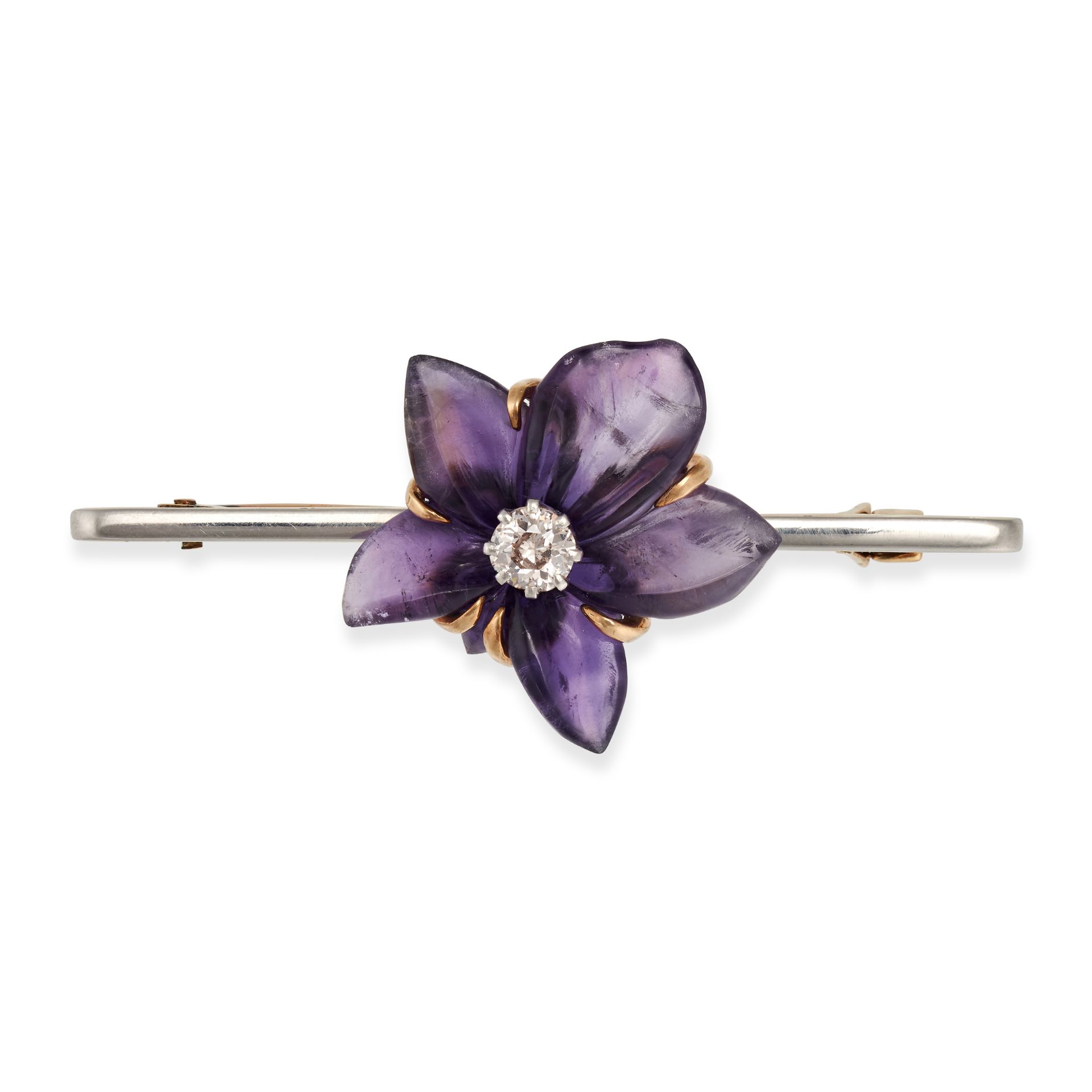 AN AMETHYST AND DIAMOND FLOWER BROOCH in yellow gold and platinum, comprising a carved amethyst f...