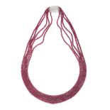 A RUBY BEAD NECKLACE comprising five strands of faceted ruby beads, no assay marks, 53.0cm, 71.0g.