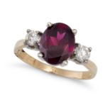 A GARNET AND DIAMOND THREE STONE RING in 9ct yellow gold, set with an oval cut garnet between two...