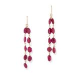 A PAIR OF RUBY TASSEL EARRINGS in yellow gold, each comprising two rows of polished ruby beads, t...