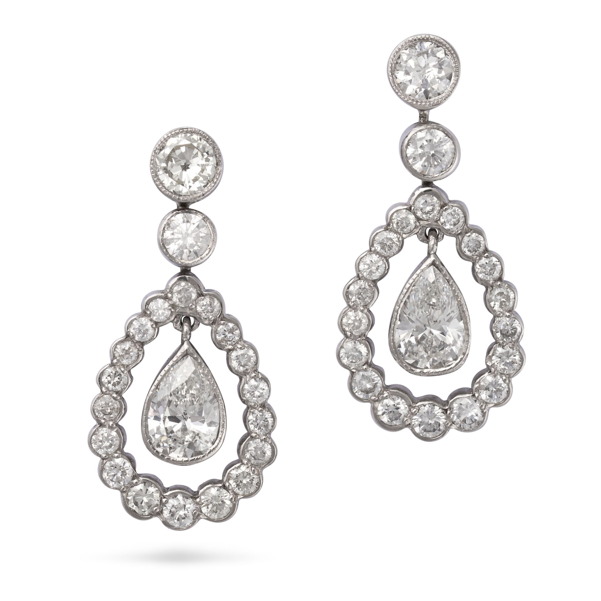 A PAIR OF DIAMOND DROP EARRINGS in 18ct white gold, each comprising a row of round brilliant cut ...