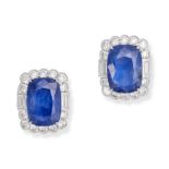 A PAIR OF SAPPHIRE AND DIAMOND EARRINGS in 18ct white gold, each set with a cushion cut sapphire ...