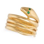 AN EMERALD SNAKE RING in 18ct yellow gold, designed as a coiled snake, the eyes set with round cu...