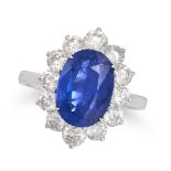 A SAPPHIRE AND DIAMOND CLUSTER RING in 18ct white gold, set with an oval cut sapphire of 4.05 car...