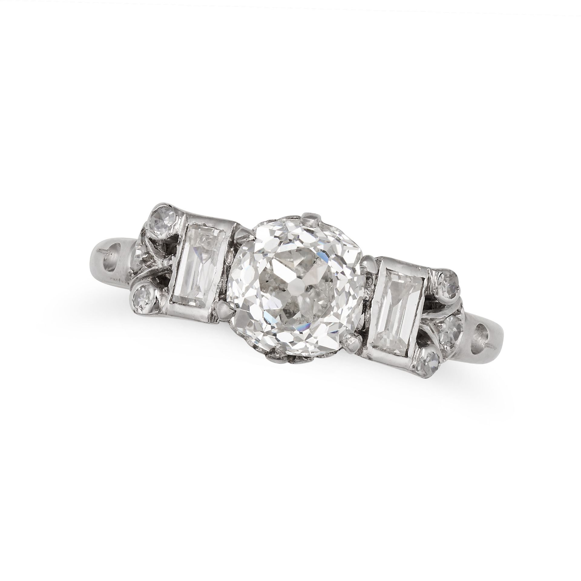 A DIAMOND DRESS RING in platinum, set with an old cut diamond of approximately 1.10 carats, flank...