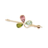 AN ANTIQUE MULTIGEM CLOVER BROOCH in 15ct yellow gold, designed as a three leaf clover set with a...