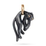 CARTIER, A PANTHERE PENDANT in 18ct yellow gold and silverium, designed as a panther hanging from...