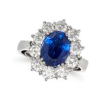 A SAPPHIRE AND DIAMOND CLUSTER RING in white gold, set with an oval cut sapphire of 3.60 carats i...