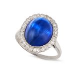 A BURMA NO HEAT SAPPHIRE AND DIAMOND RING in platinum, set with a cabochon sapphire of 12.32 cara...