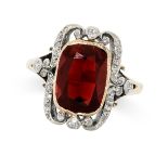 NO RESERVE - A GARNET AND DIAMOND RING in 18ct yellow gold, set with a cushion cut garnet in a st...