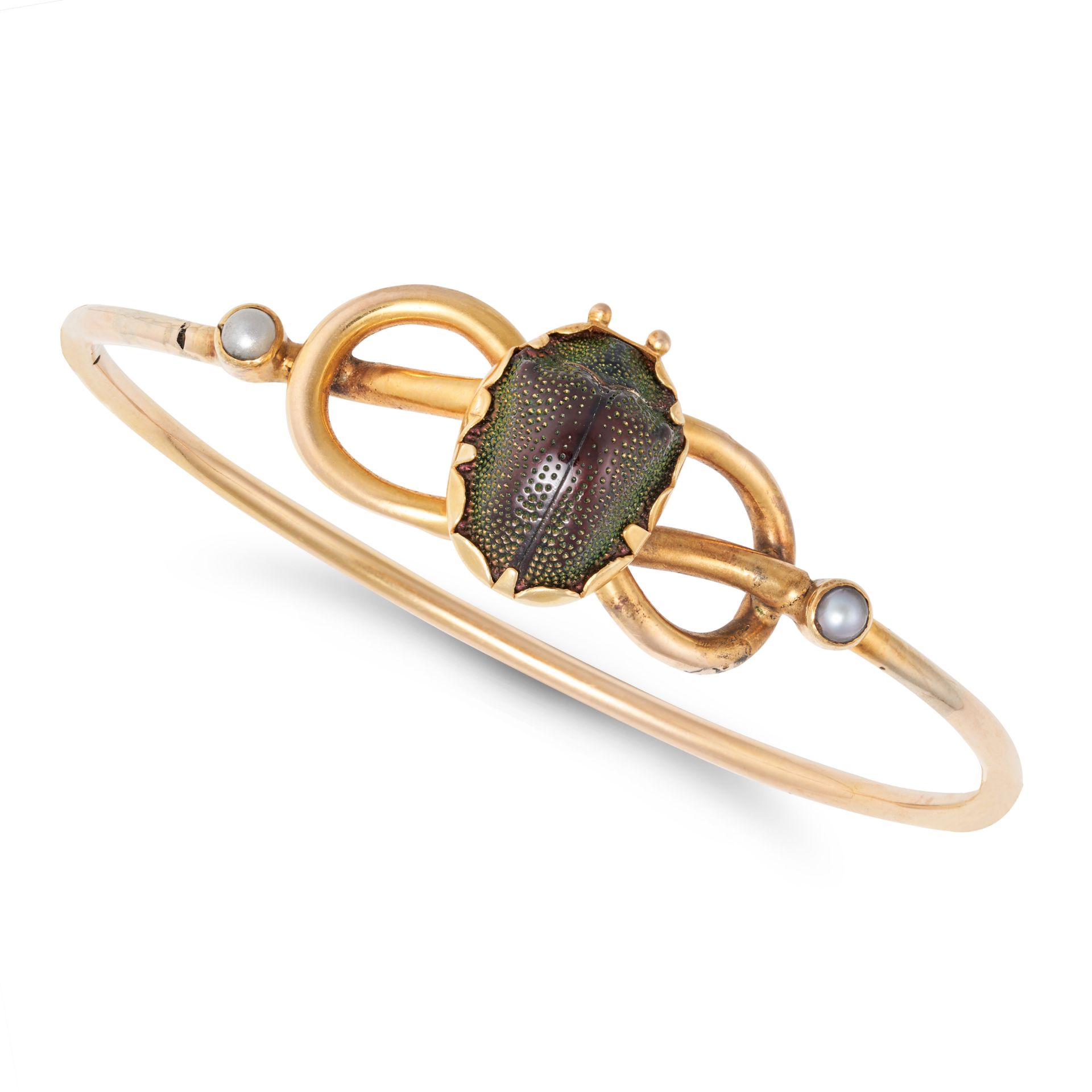 NO RESERVE - A PEARL AND SCARAB BEETLE BANGLE in yellow gold, the hinged bangle in a knotted desi...