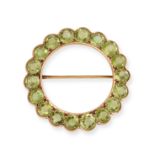 NO RESERVE - A PERIDOT CIRCLE BROOCH in yellow gold, set all around with a row of round cut perid...