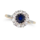 A SAPPHIRE AND DIAMOND CLUSTER RING in 18ct yellow gold and platinum, set with a round cut sapphi...