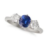 A SAPPHIRE AND DIAMOND THREE STONE RING in platinum, set with an oval cut sapphire of approximate...