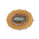 AN ANTIQUE CAT'S EYE CHRYSOBERYL AND PEARL MOURNING BROOCH in 15ct yellow gold, set with a caboch...