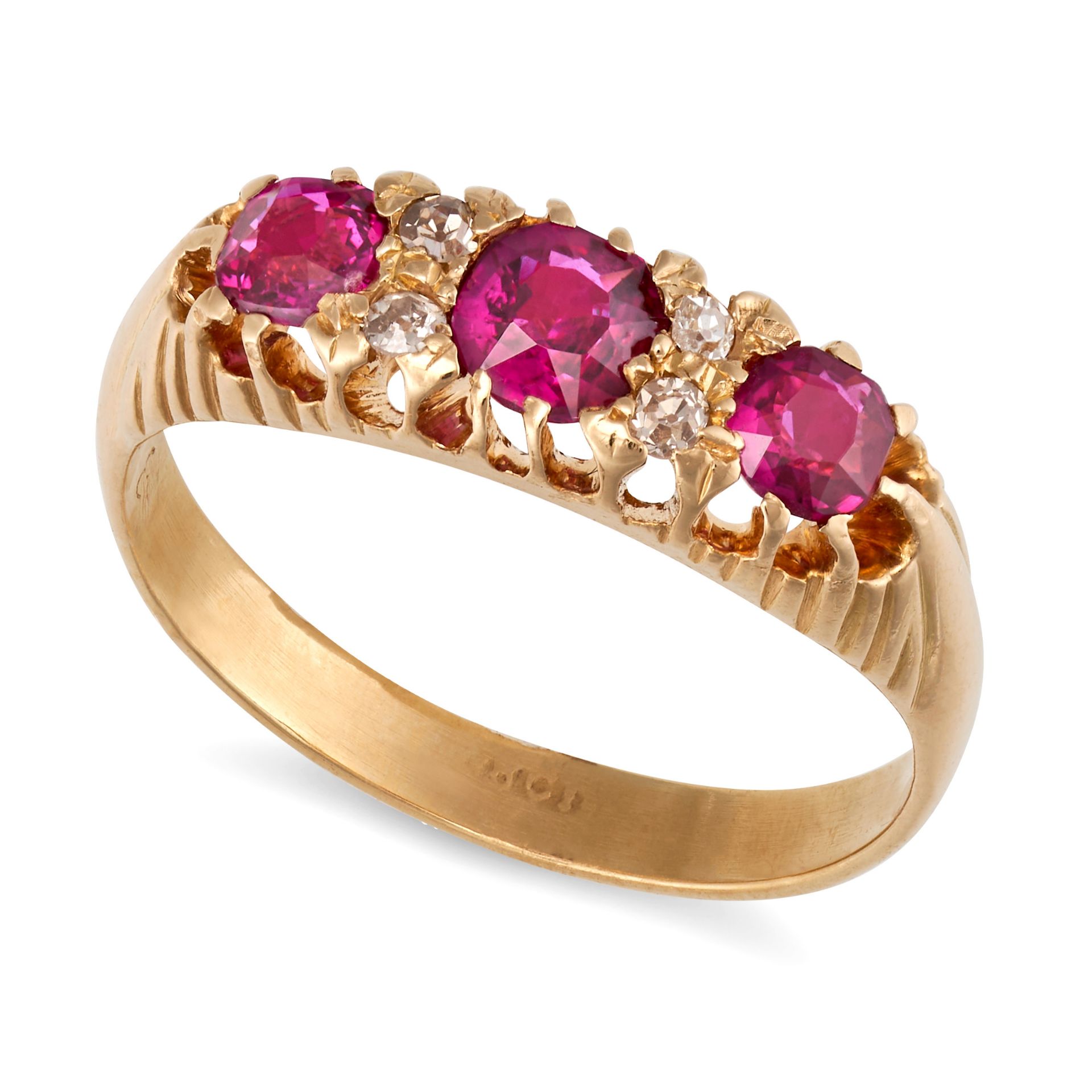 A VINTAGE RUBY AND DIAMOND RING in 18ct yellow gold, set with three cushion cut rubies, punctuate...