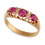 A VINTAGE RUBY AND DIAMOND RING in 18ct yellow gold, set with three cushion cut rubies, punctuate...