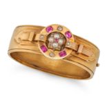 AN ANTIQUE RUBY, PEARL AND DIAMOND BANGLE in yellow gold, the hinged bangle set with cushion cut ...