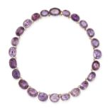 AN ANTIQUE AMETHYST RIVIERE NECKLACE in yellow gold, set with oval cut amethysts in pinched colle...