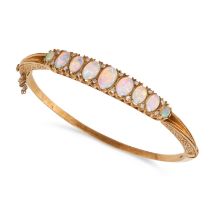 A VINTAGE OPAL AND DIAMOND BANGLE in 18ct yellow gold, the hinged bangle set with graduated caboc...