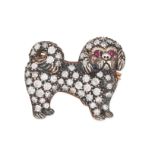 A DIAMOND AND RUBY DOG BROOCH in yellow gold and silver, designed as a Pekingese, set throughout ...