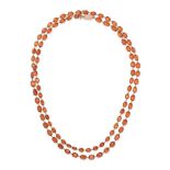 AN ANTIQUE HESSONITE GARNET SAUTOIR NECKLACE in yellow gold, comprising a row of cushion cut hess...