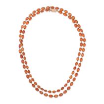 AN ANTIQUE HESSONITE GARNET SAUTOIR NECKLACE in yellow gold, comprising a row of cushion cut hess...