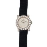 OMEGA - A VINTAGE LADIES OMEGA WRISTWATCH in platinum, manual wind movement, the circular silvere...