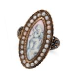 NO RESERVE - AN ENAMEL AND PEARL CHERUB RING in 18ct yellow gold, the navette face decorated with...