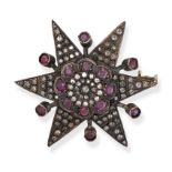 A RUBY AND DIAMOND STAR BROOH in yellow gold and silver, designed as a six rayed star set through...