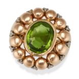 A PERIDOT AND DIAMOND DRESS RING in yellow gold, set with an oval cut peridot, accented by single...