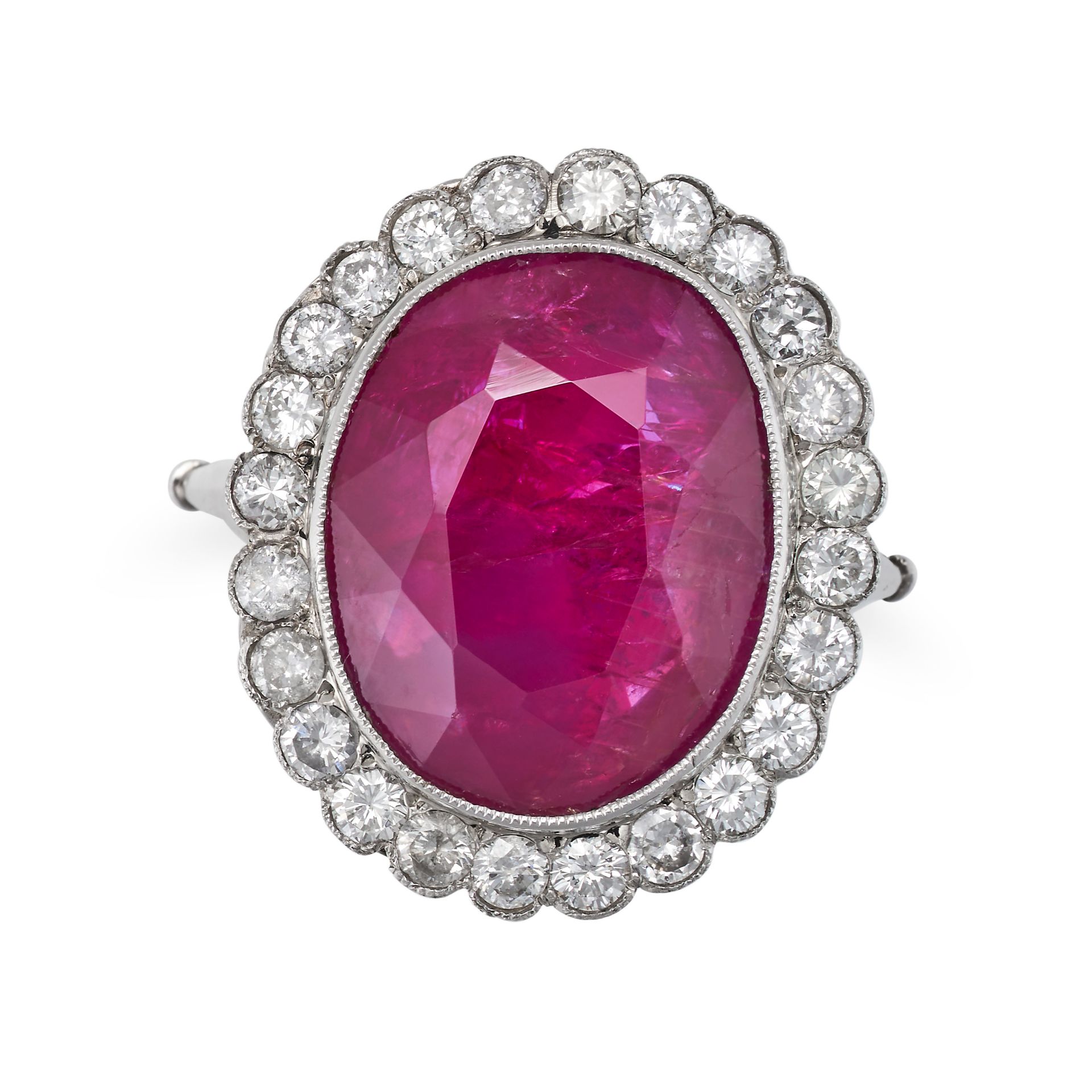 A 9.96 CARAT BURMA NO HEAT RUBY AND DIAMOND CLUSTER RING in platinum, set with an oval cut ruby o...