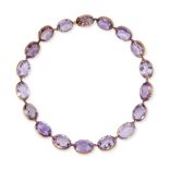 AN ANTIQUE VICTORIAN AMETHYST RIVIERE NECKLACE in yellow gold, comprising a single row of oval cu...