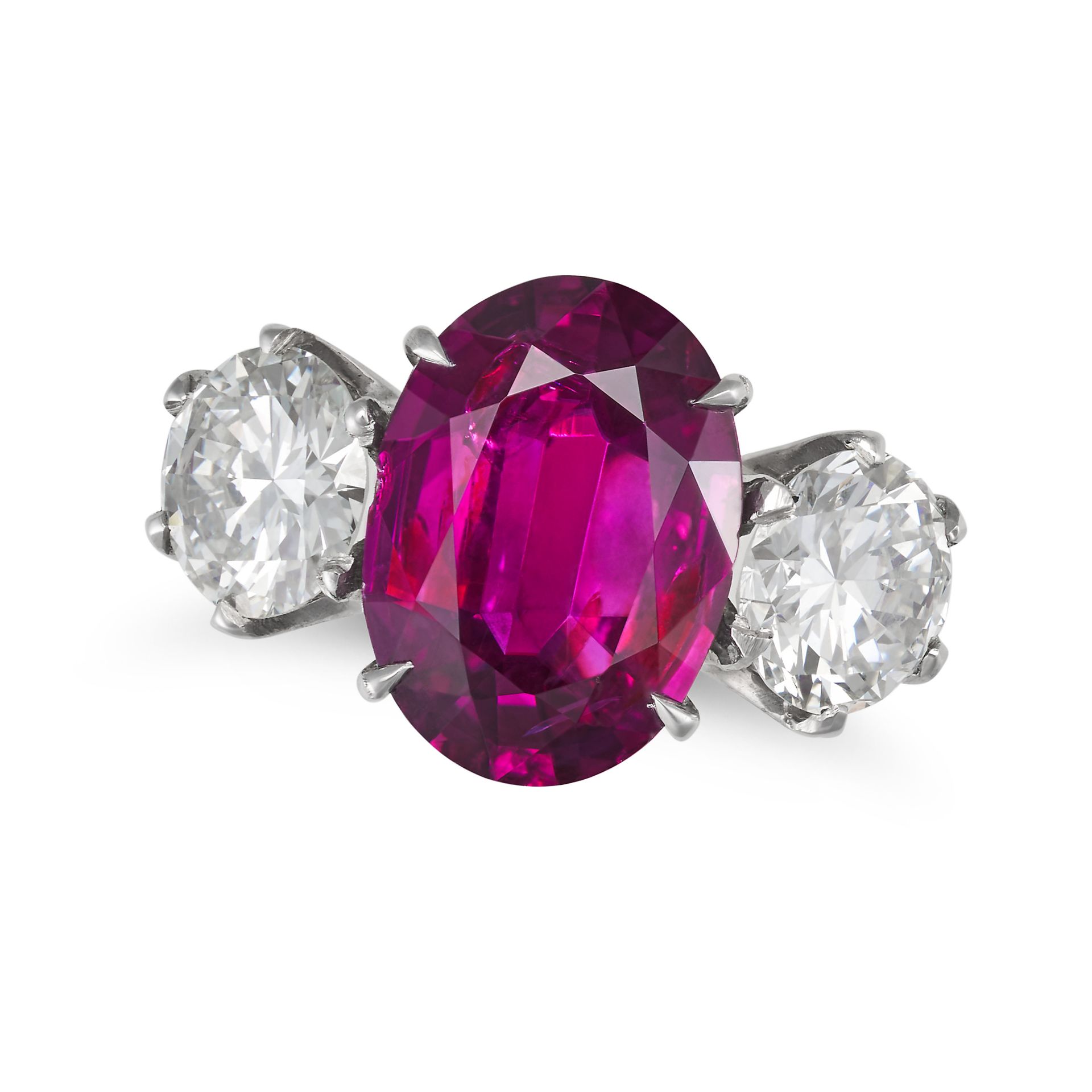 A FINE UNHEATED RUBY AND DIAMOND THREE STONE RING in white gold, set with an oval cut ruby of 4.7...