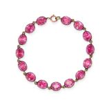 AN ANTIQUE PINK PASTE BRACELET in yellow gold, comprising a single row of oval cut pink paste sto...