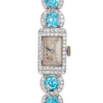 AN ANTIQUE ART DECO BLUE ZIRCON AND DIAMOND COCKTAIL WATCH in platinum and steel, the rectangular...