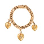 AN ANTIQUE DIAMOND HEART CHARM BRACELET in 15ct yellow gold, comprising a curb link bracelet, sus...