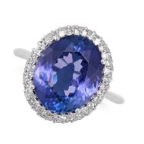 A TANZANITE AND DIAMOND CLUSTER RING in platinum, set with an oval cut tanzanite of 7.41 carats i...